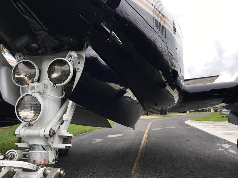 The landing gear of the Beechcraft King Air 90C, showing the aircraft's undercarriage and tow bar attachment.