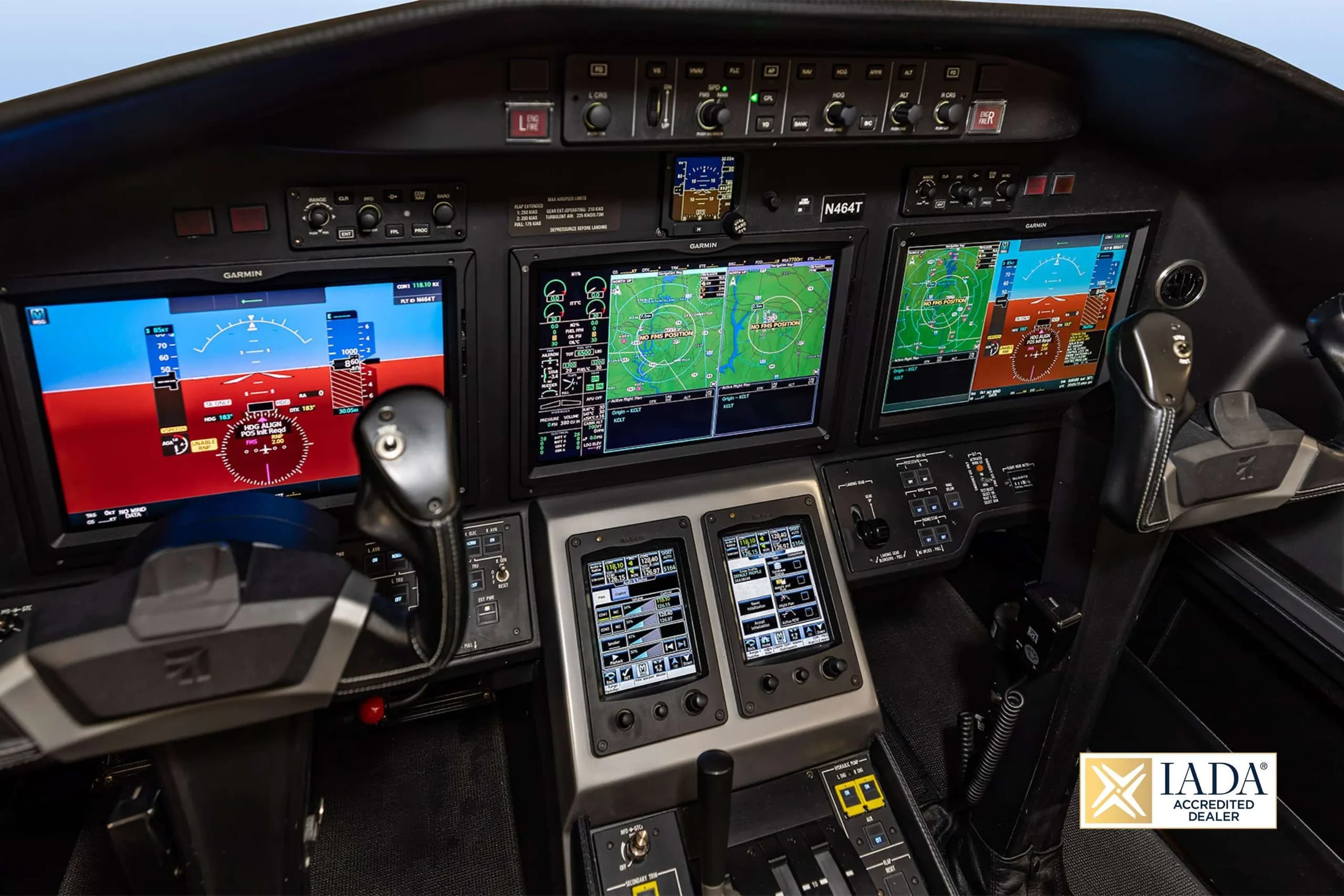 A close-up view of the pilot's side of the N464T cockpit, showing the control yoke and Garmin displays.