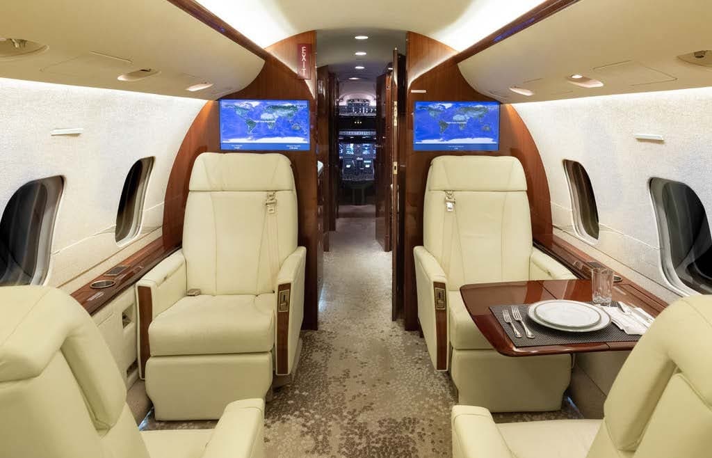 The interior of the Bombardier Challenger 300 features comfortable seating and luxurious amenities.