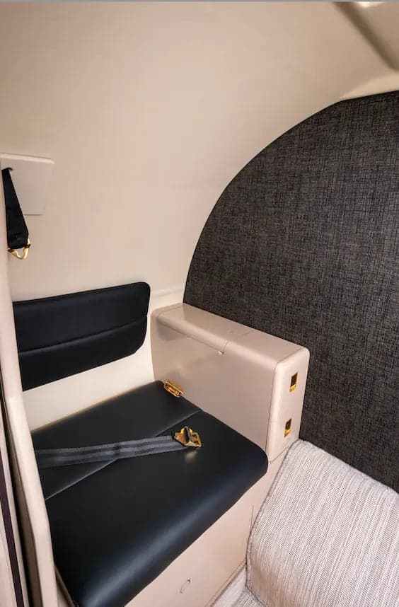 Close-up of a seat and side table inside the Cessna Citation Ultra cabin.