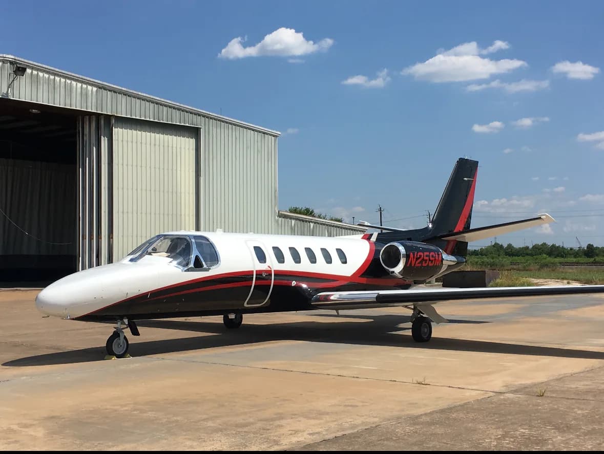 Cessna Citation with black and red paint scheme.