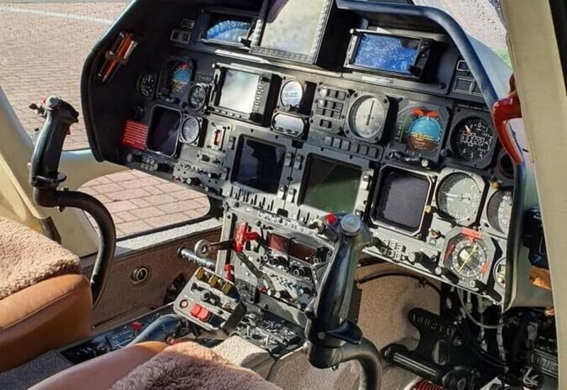 The helicopter's cockpit features a complex array of instruments and controls.