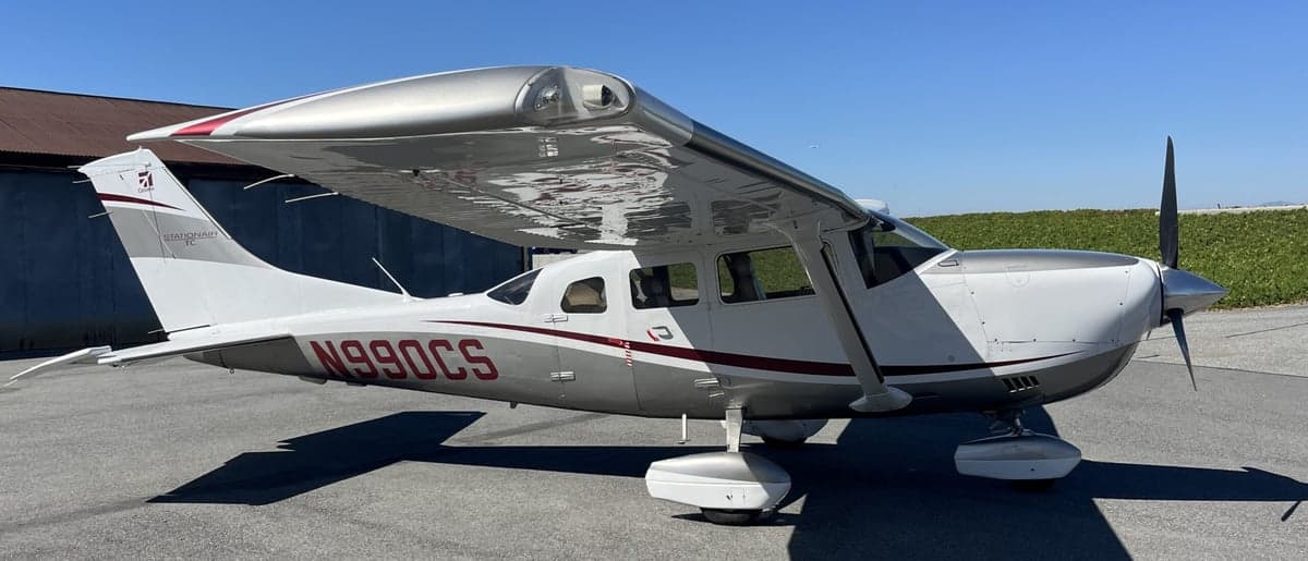 Side view of the Cessna T206H Stationair TC aircraft with registration N990CS.