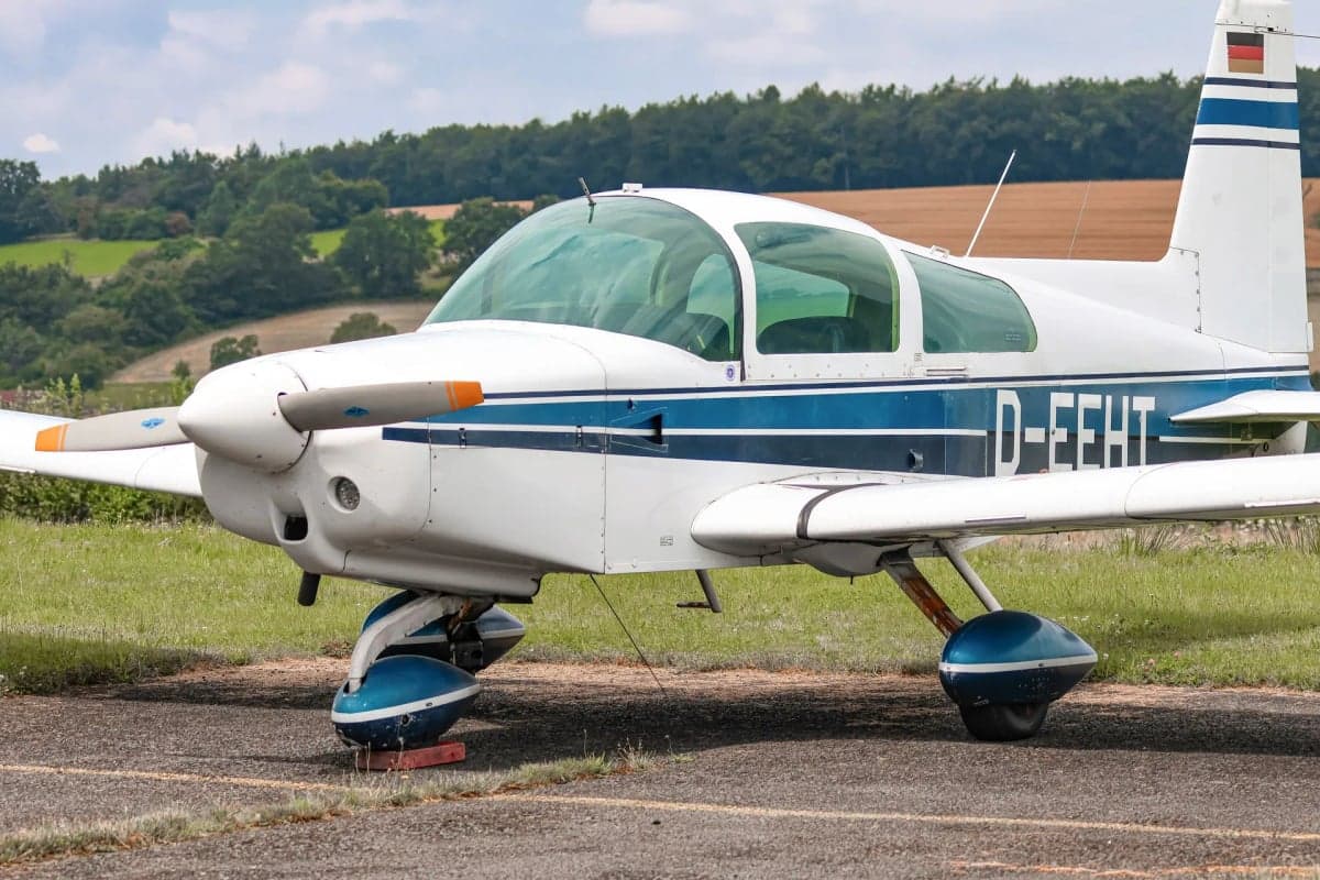 Close-up of the front of a white and blue aircraft with the registration D-EEHT.