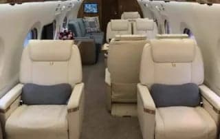 Interior of the aircraft with seats and a couch.