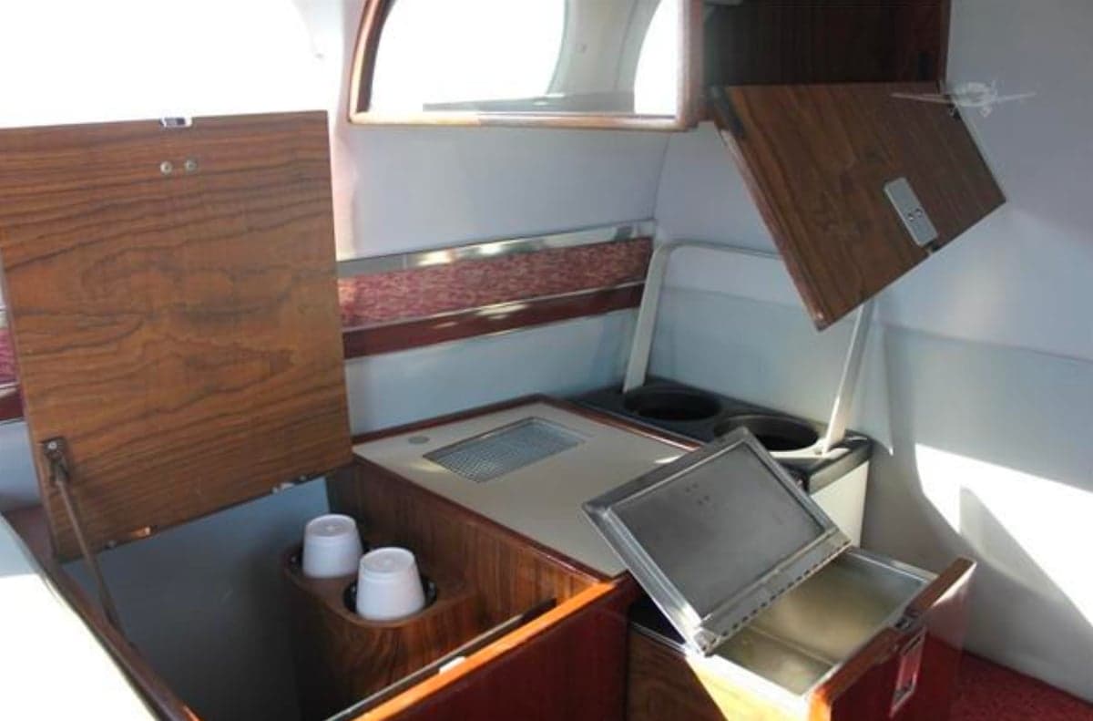 Interior view of the Cessna 421 Golden Eagle cabin with storage and refreshment area.