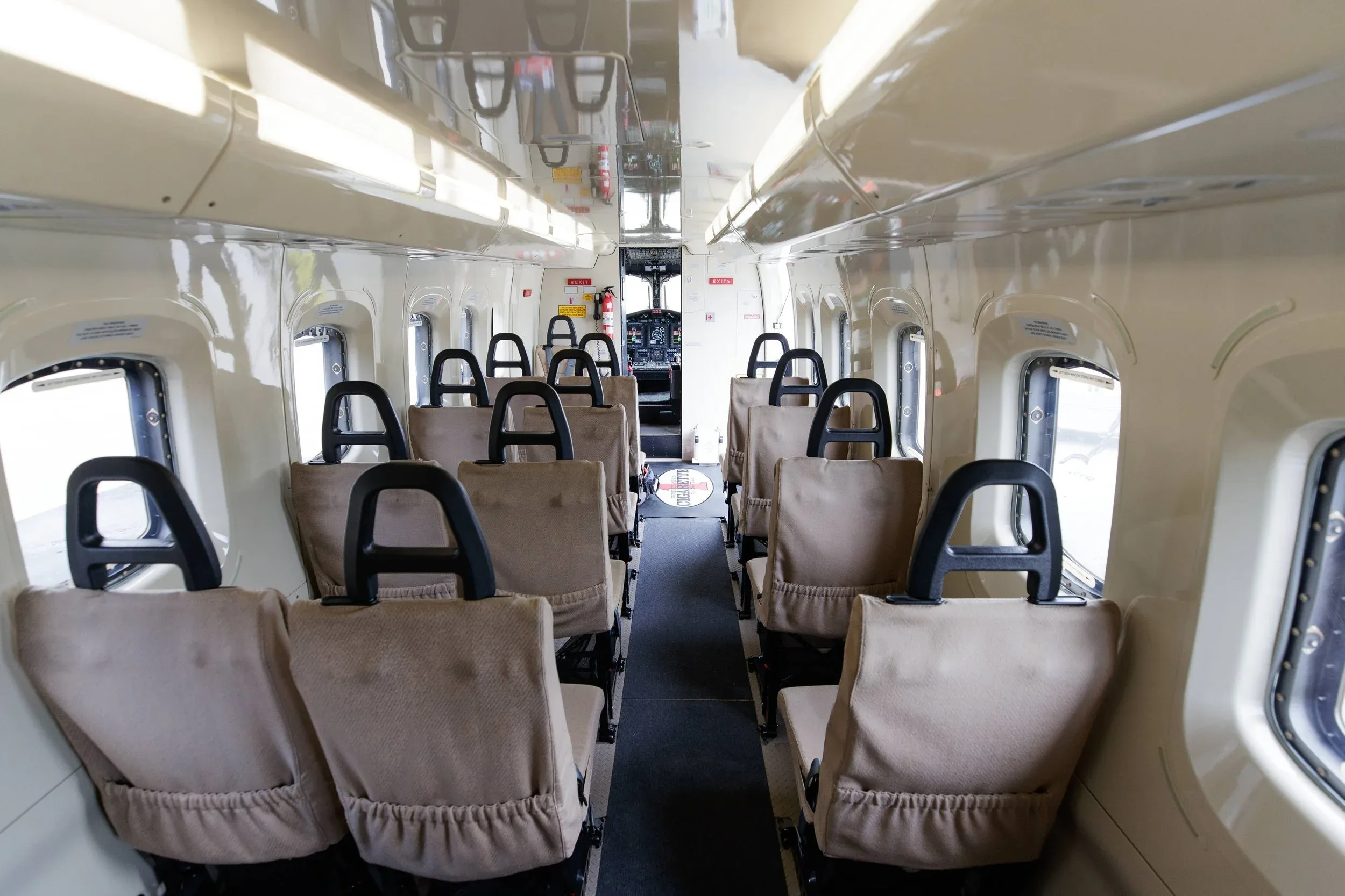 Interior view of the helicopter cabin with beige seats.