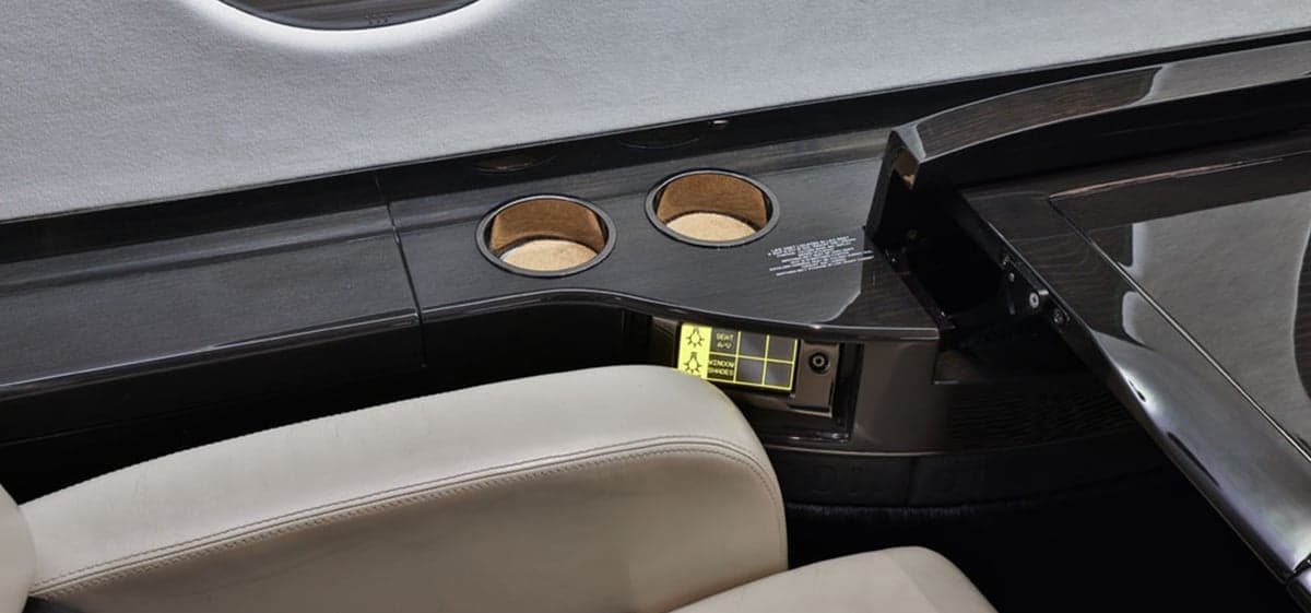 Close-up of a table with cupholders in the aircraft interior.