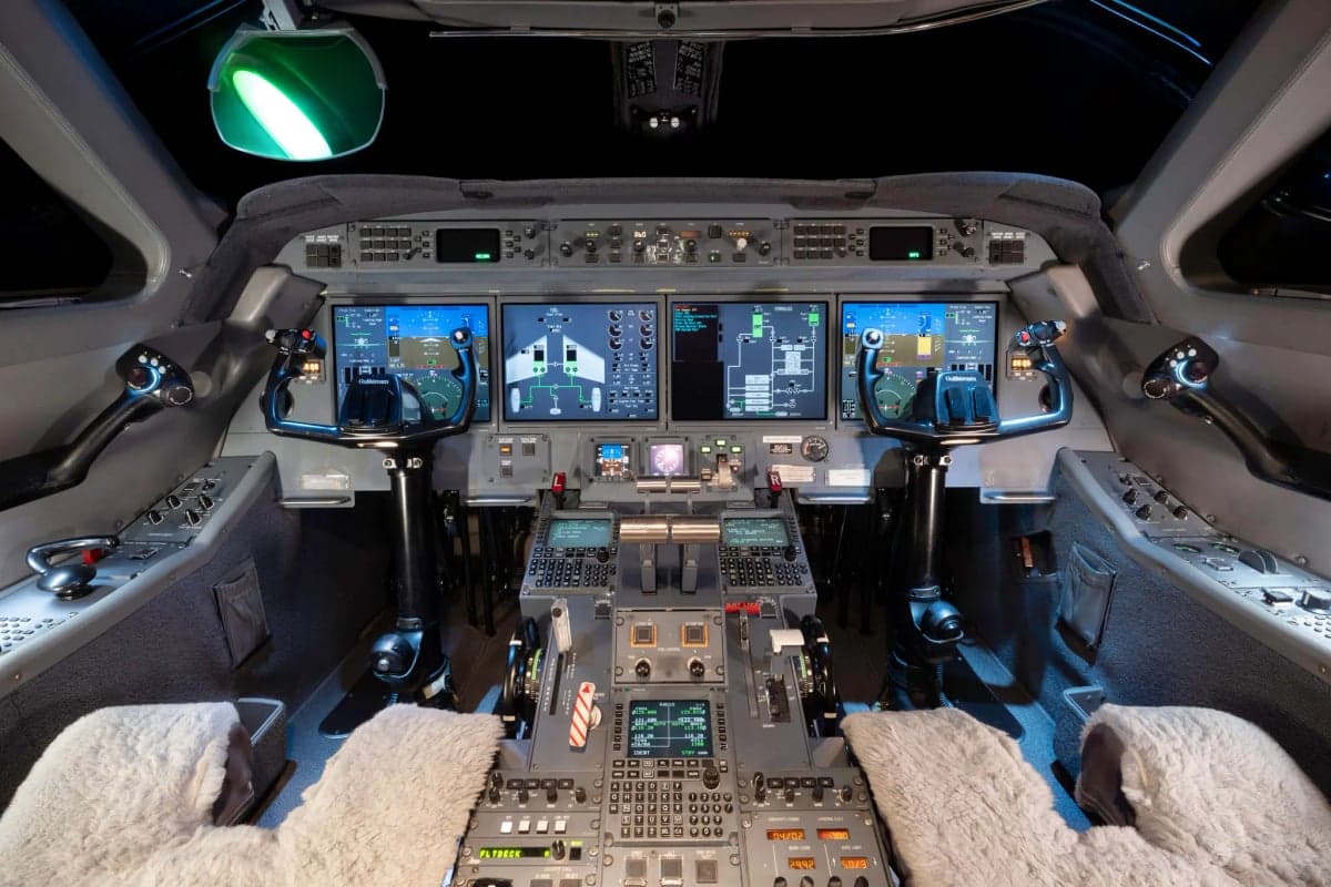 Full view of the Gulfstream G450 cockpit with multiple display screens and controls.