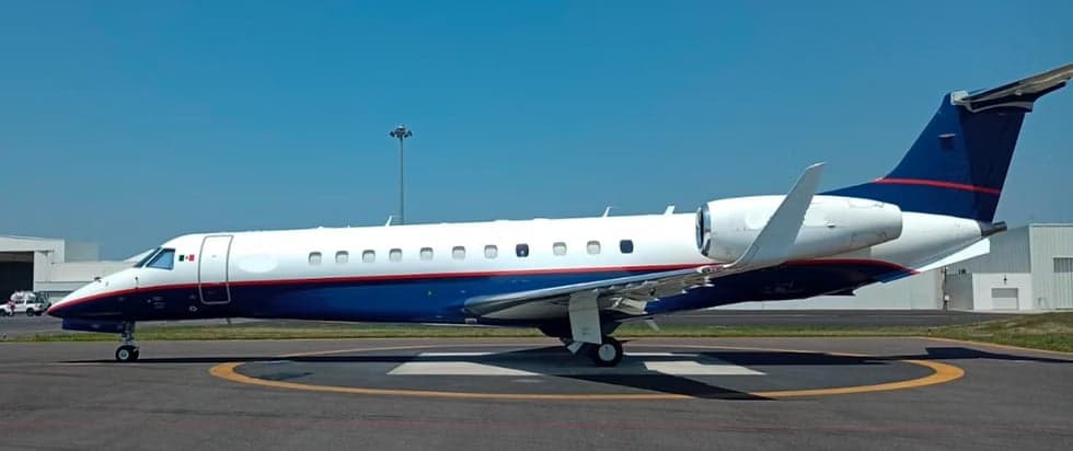 Embraer Legacy 650 parked on a circular pad.