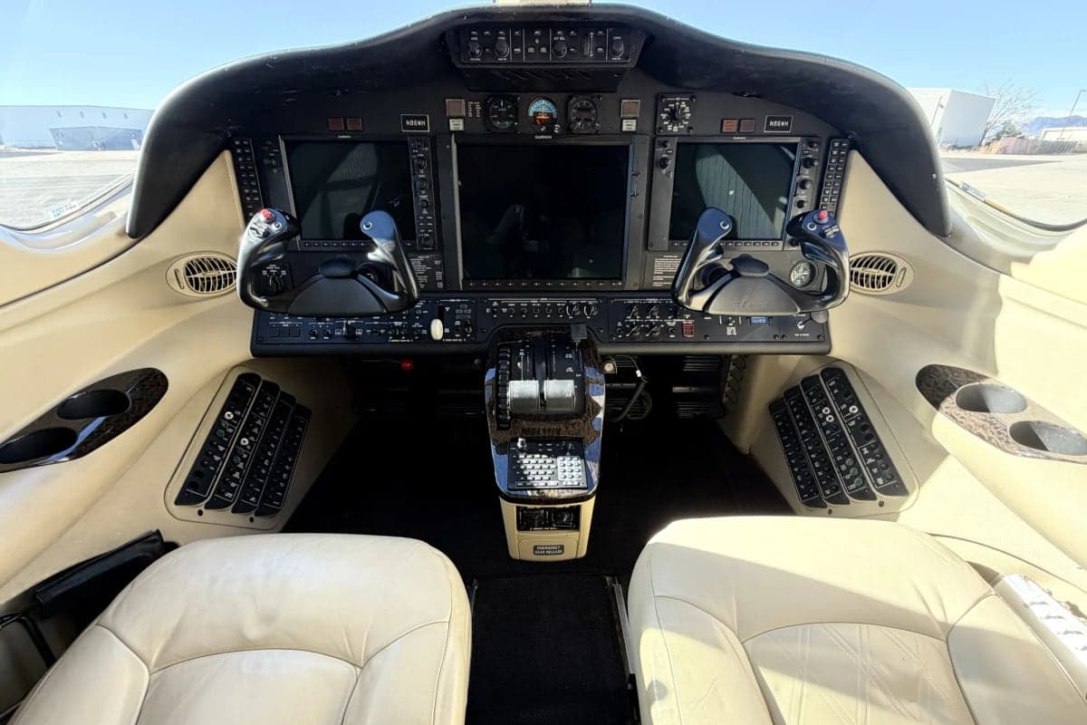 The cockpit of the Citation Mustang, showing the instrument panel and seats.