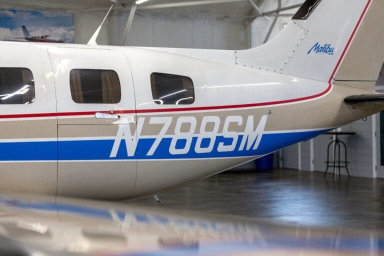 A close-up of the tail and N788SM tail number of the Malibu aircraft.