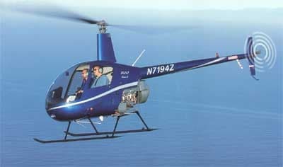 Blue Robinson R22 helicopter in flight with registration N7194Z.