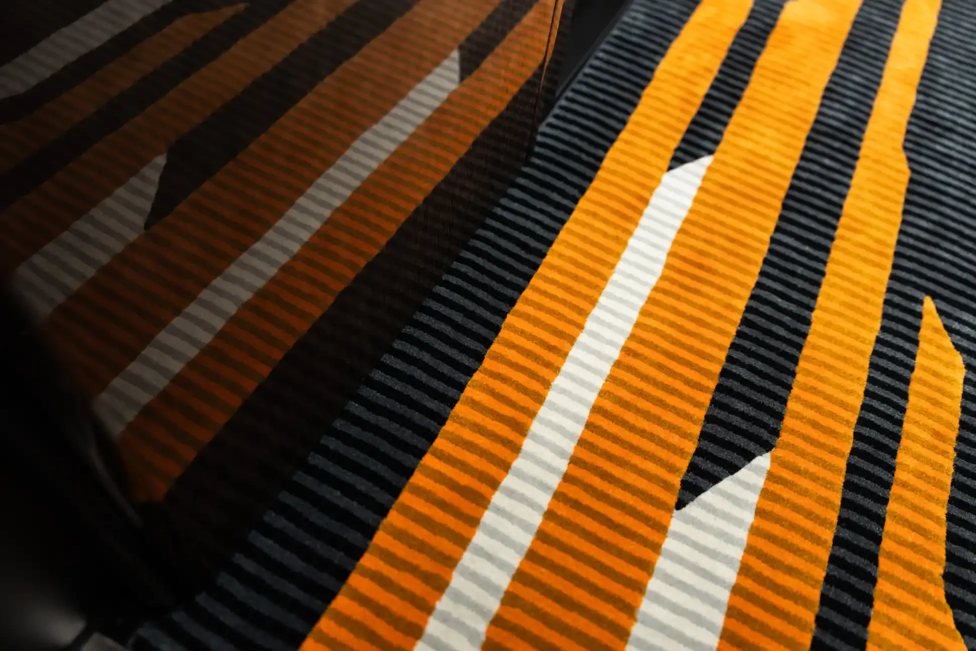 Close-up of the aircraft's interior showing the orange and gray striped carpet.