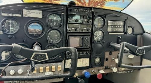 The instrument panel of a Cessna 182 Skylane aircraft, showing various gauges and controls.
