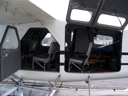 The interior cabin of a de Havilland Beaver floatplane with the doors open.