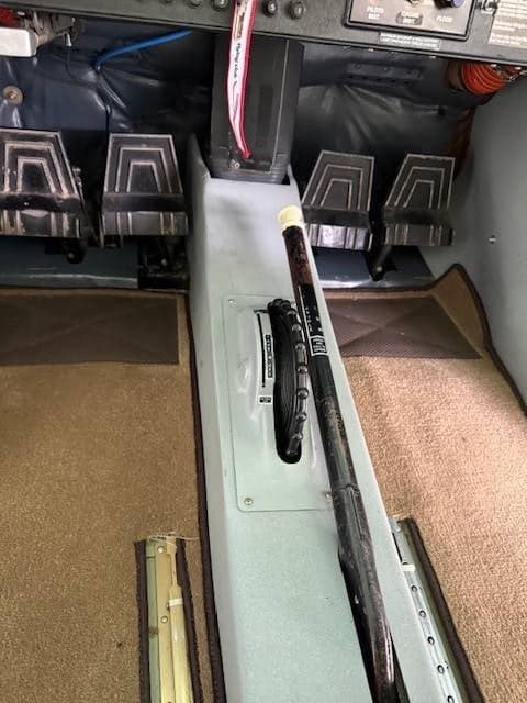 A view of the rudder pedals and central control levers in the Cessna cockpit.