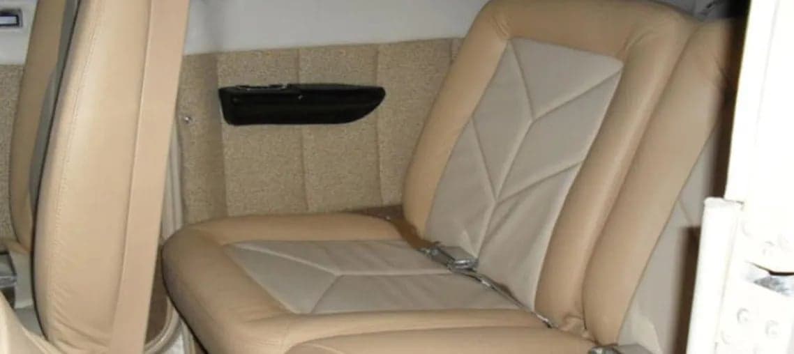 Aircraft interior showing tan leather seats.