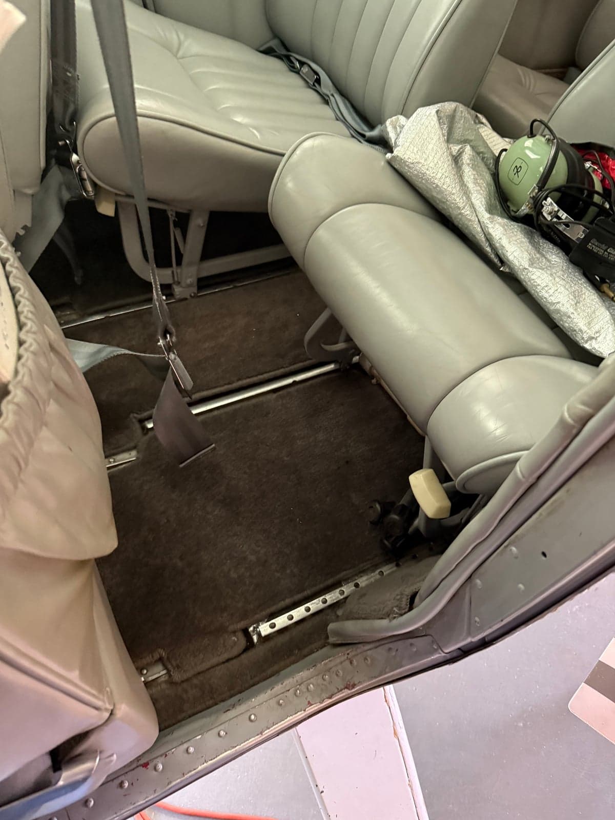 The interior of the aircraft showing the rear seats and floor.