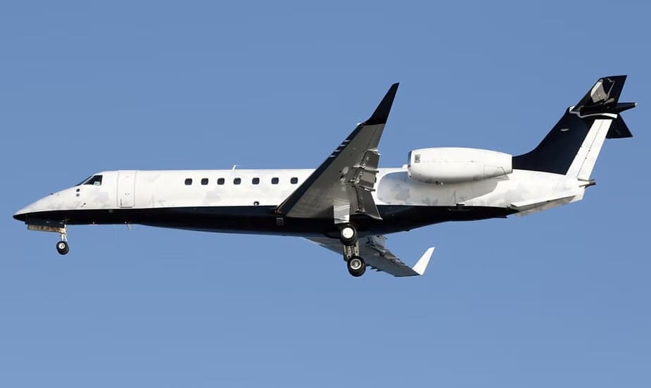 Embraer Legacy 600 in flight with a white and black paint scheme.
