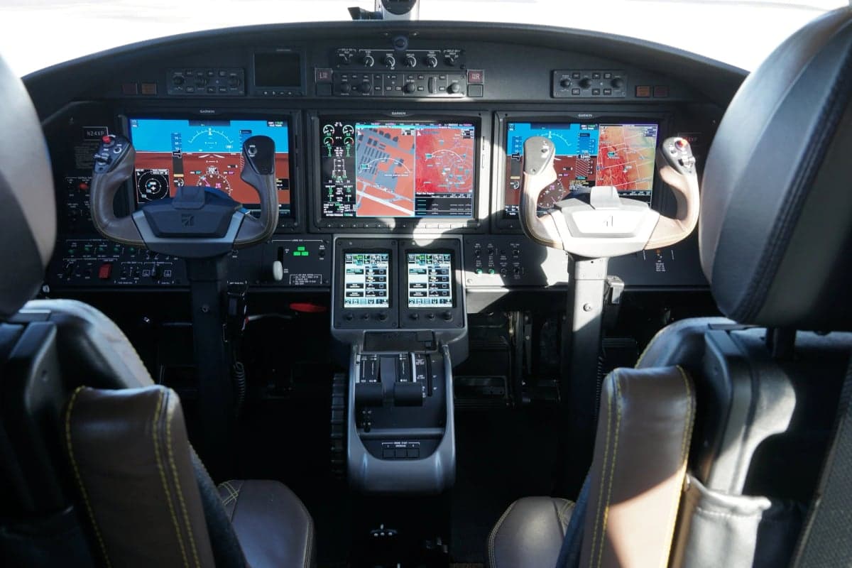 View of the cockpit instrument panel and seats of the Citation M2 jet.