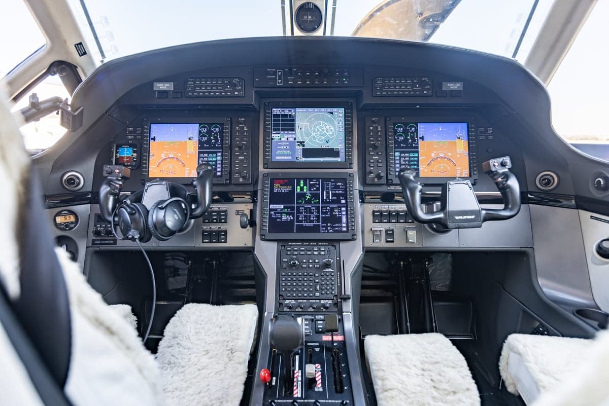 The cockpit of a Pilatus PC-24 aircraft, featuring modern avionics and controls.