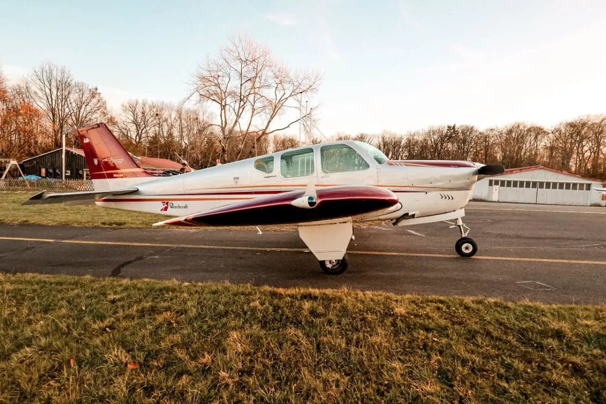 Beechcraft Bonanza N8918M parked on the runway.