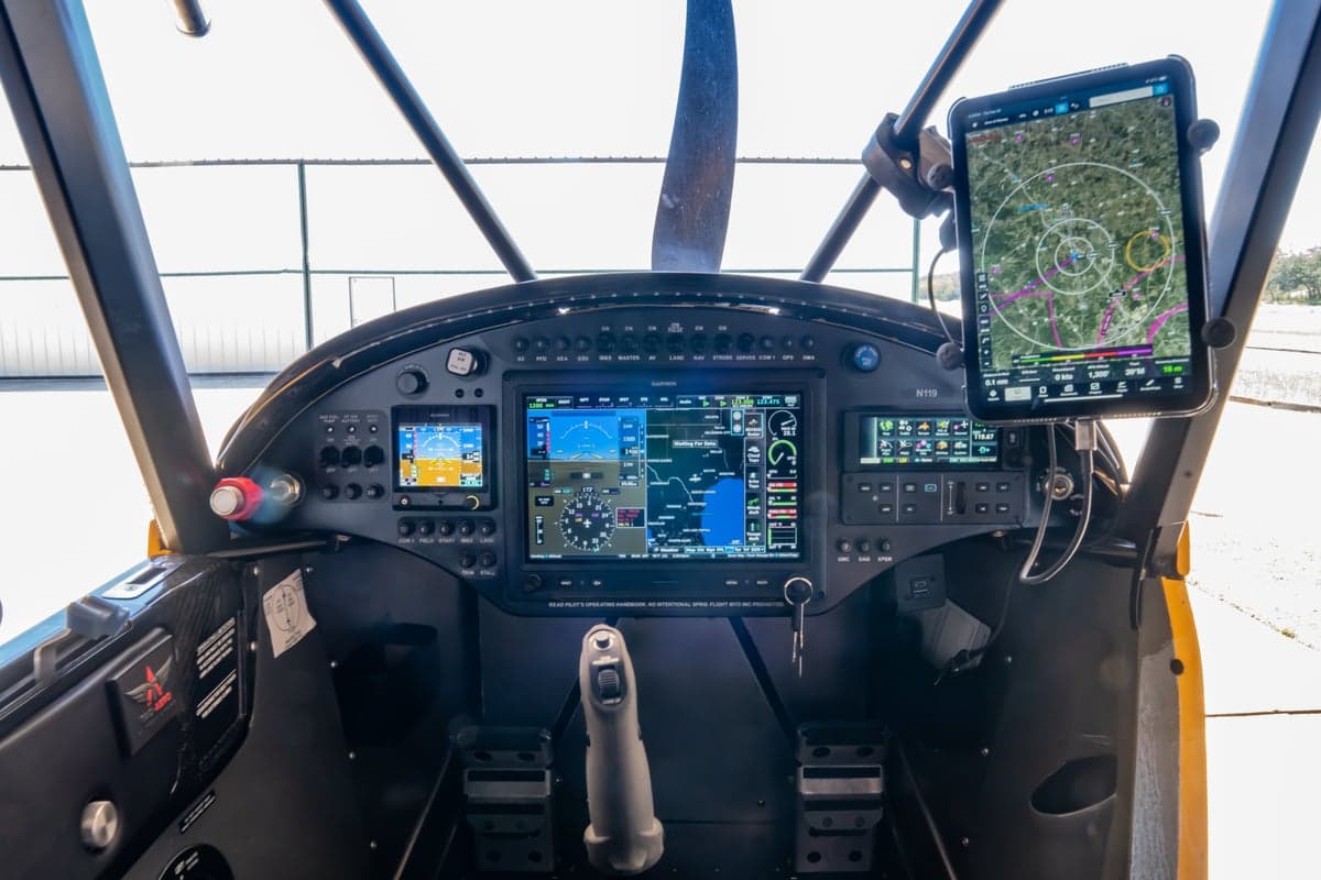 View of the NX Cub cockpit with modern avionics and an iPad mount.