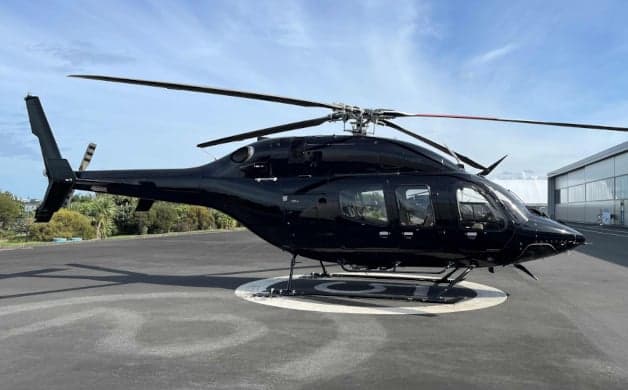 Close-up of the helicopter's instrument panel with multiple screens.
