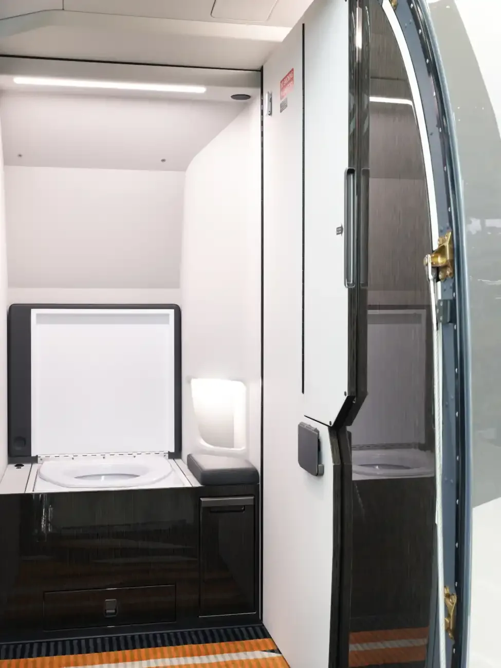 View of the aircraft's lavatory with a toilet and sink.
