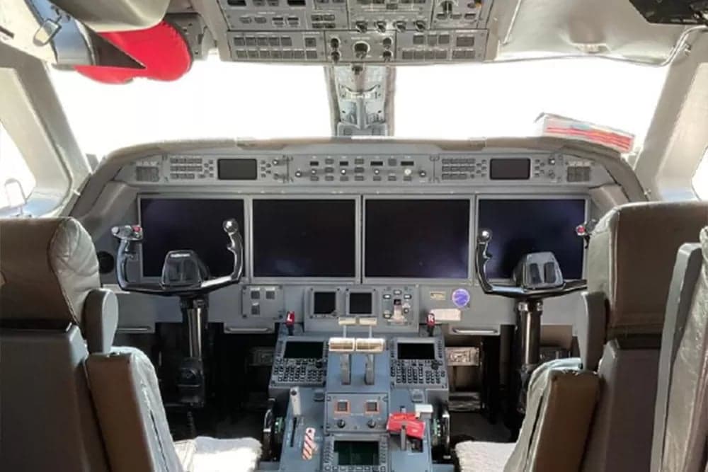View of the aircraft's cockpit with instrument panel and controls.