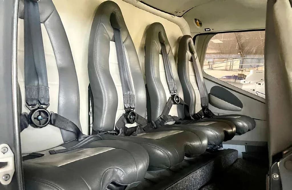 The grey and black passenger seats with seatbelts are visible inside the helicopter cabin.