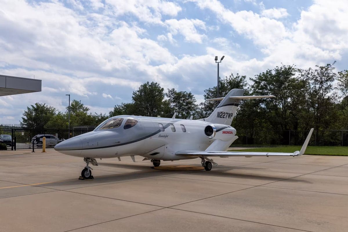 Side view of a HondaJet with registration N227WP on the tarmac.