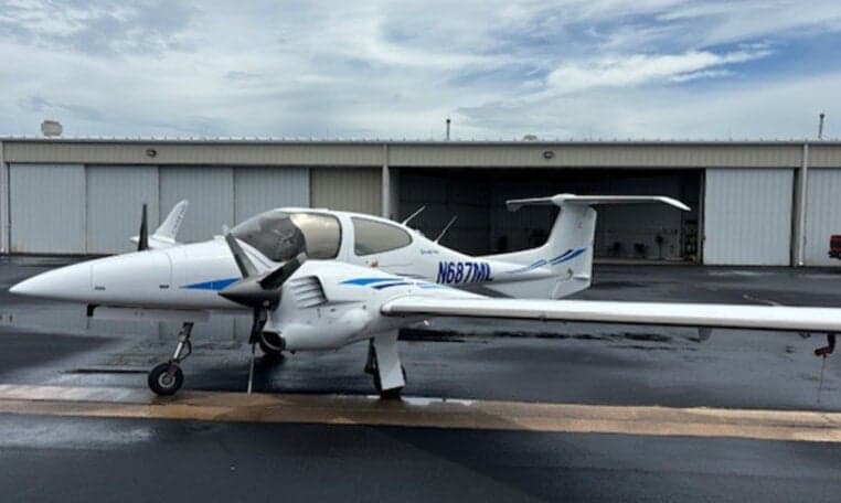 Diamond DA42-NG aircraft N687ML on the tarmac in front of a hangar.