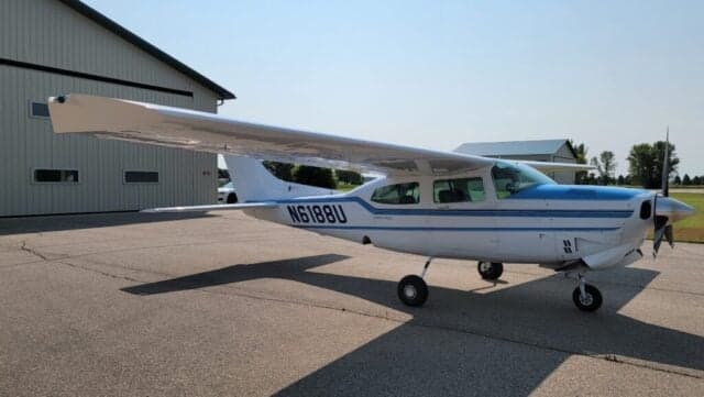 Front view of a Cessna Centurion aircraft with a blue and white paint scheme.