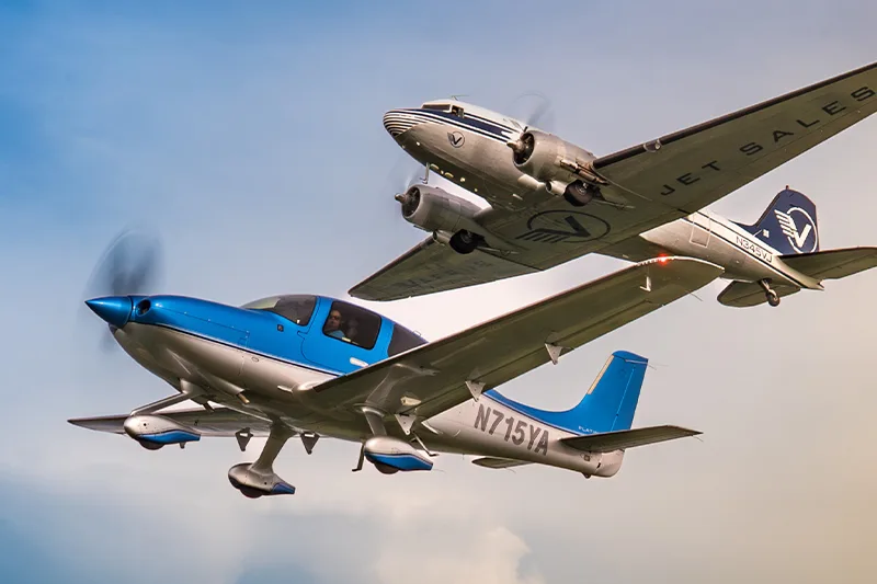 A Cirrus and a Douglas DC-3 fly in formation.