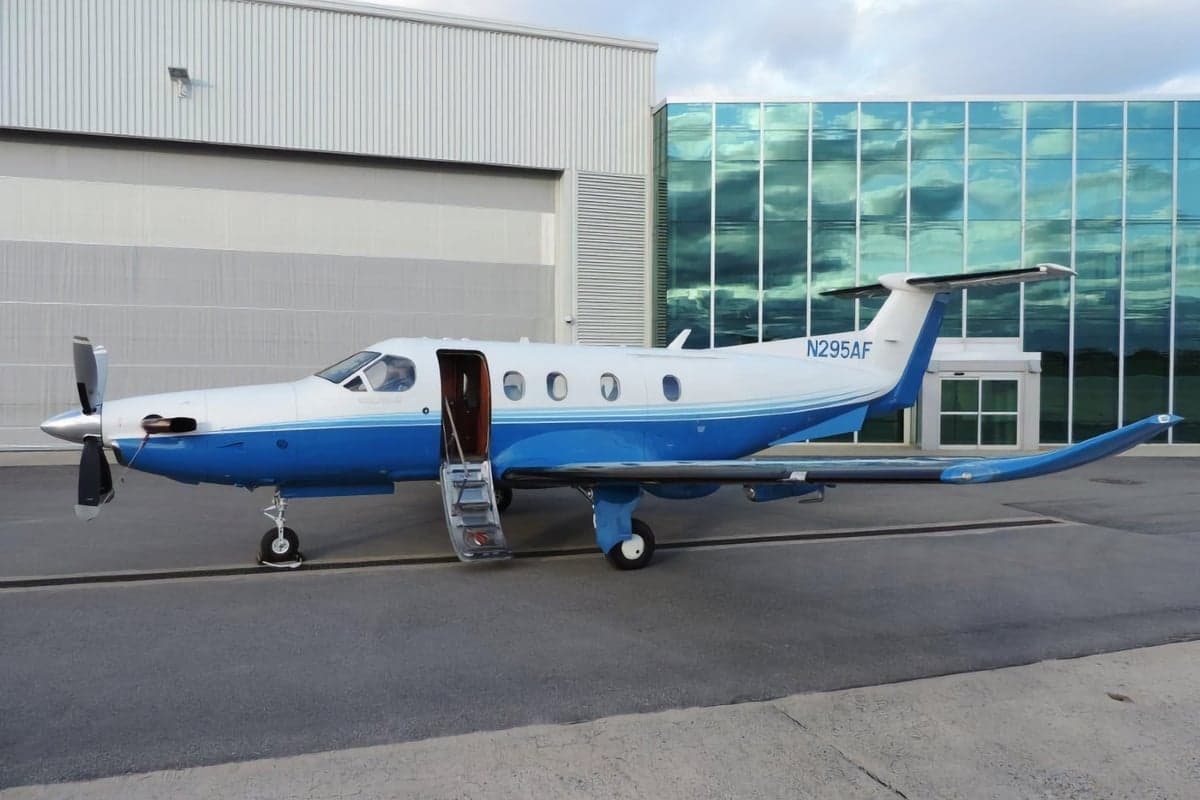 Pilatus PC-12 with blue and white paint scheme parked on the tarmac.