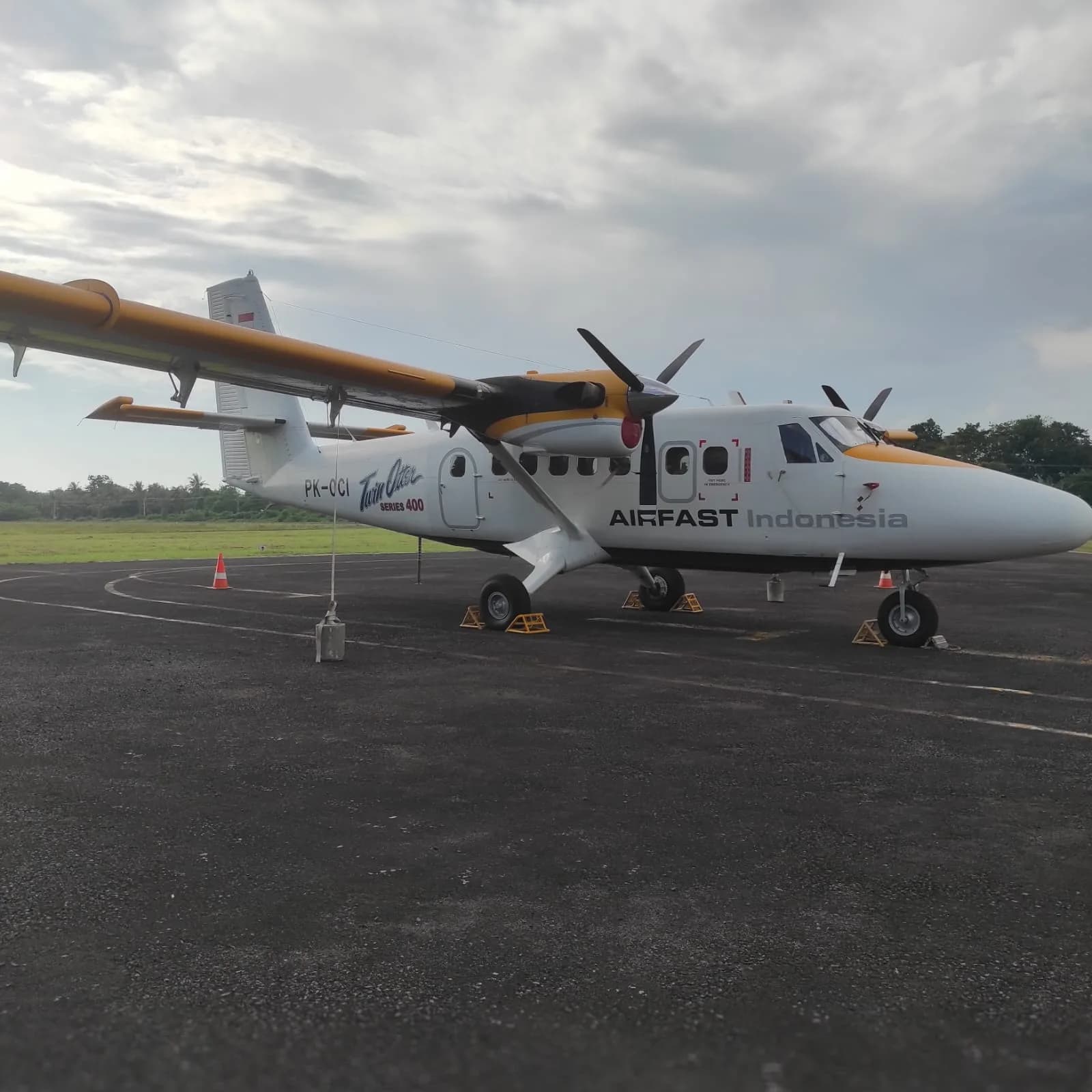 Side view of the PK-OCI Twin Otter Series 400 aircraft on the ground.