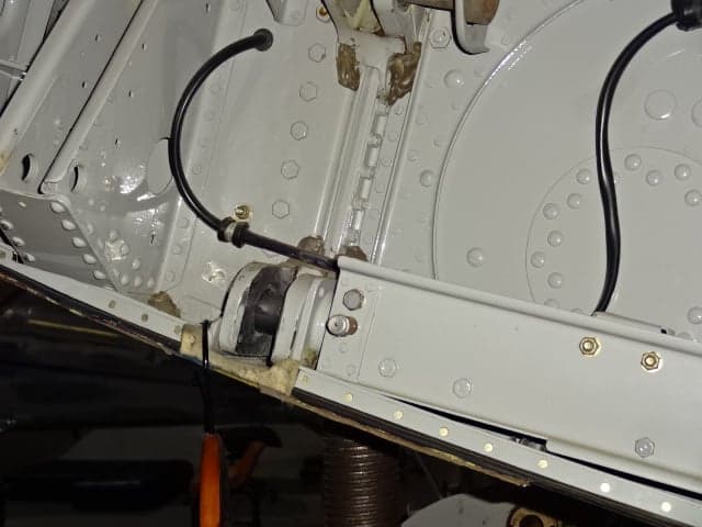 Close-up of the aircraft's internal structure with visible tubing and rivets.