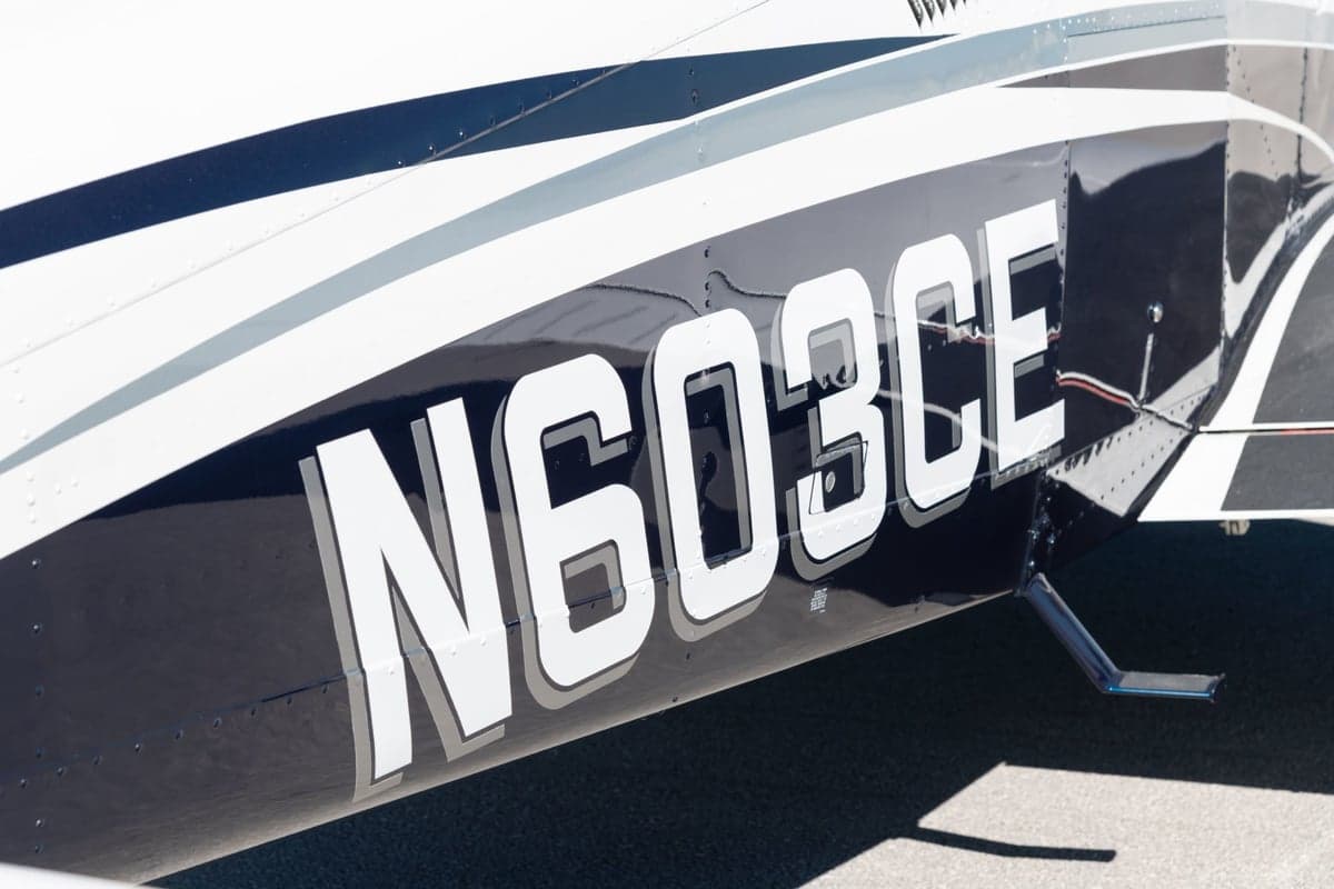 Close-up of the N603CE registration number on the aircraft's fuselage.