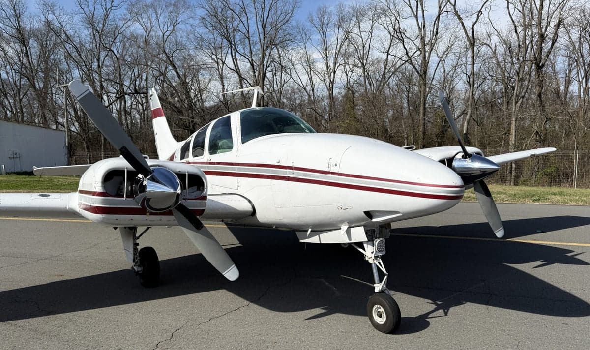 Front view of N535Q Beechcraft on the tarmac with a white and maroon paint scheme.