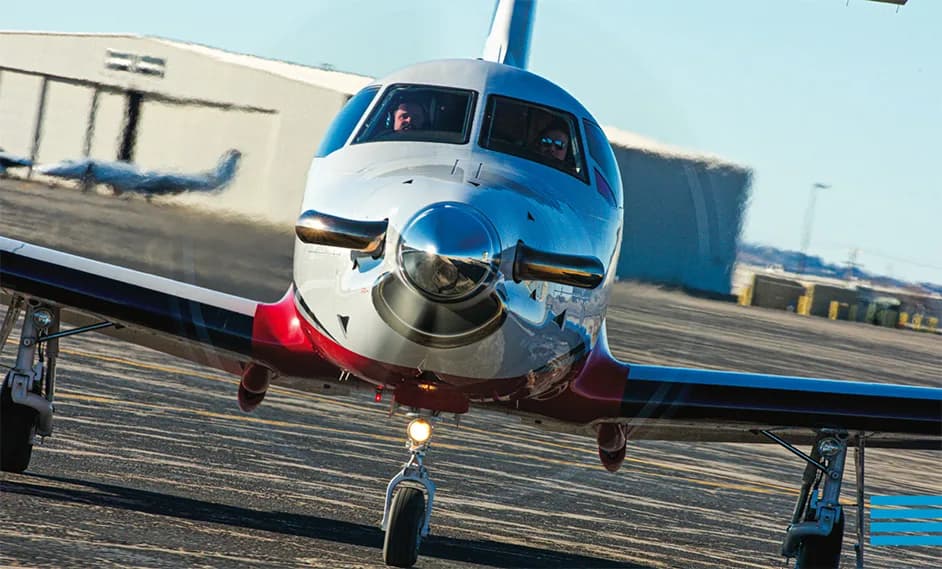 Front view of a Pilatus PC-12 aircraft on the tarmac.