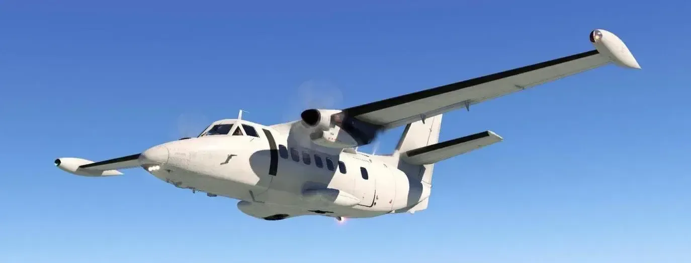 A white aircraft is flying in the sky.