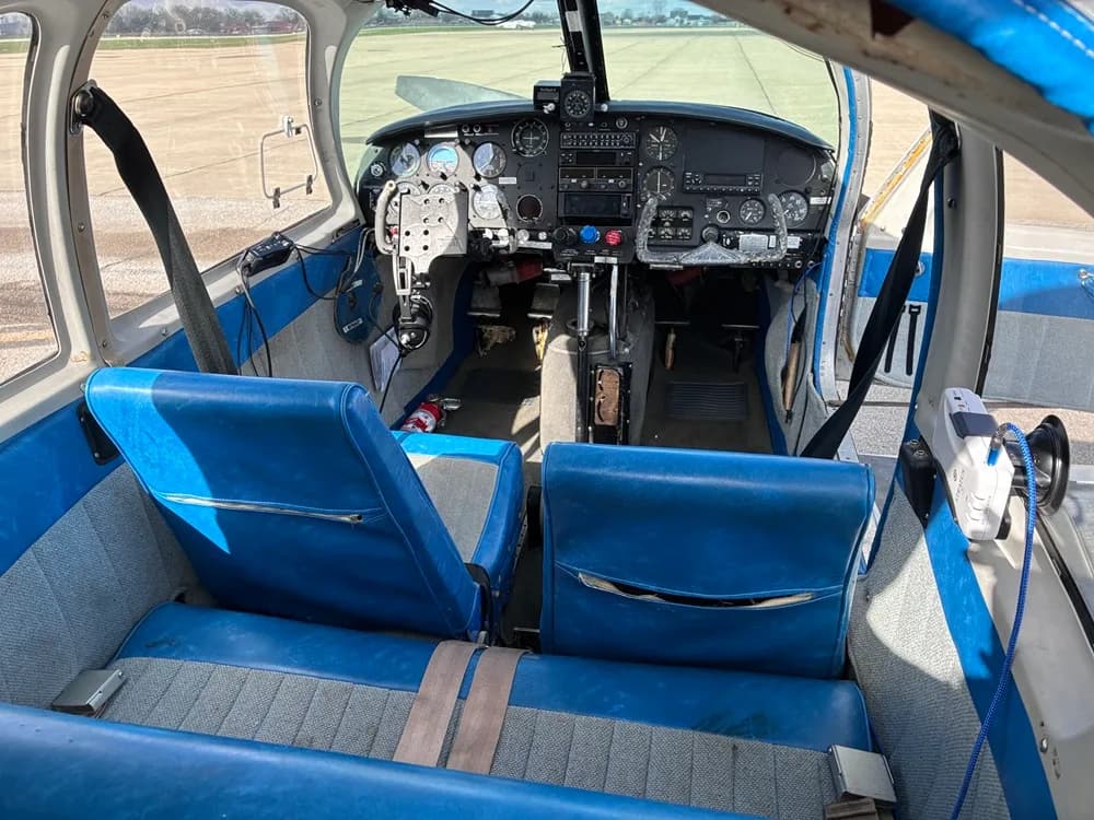 The interior of a Piper PA-28-140 Cherokee with blue seats.