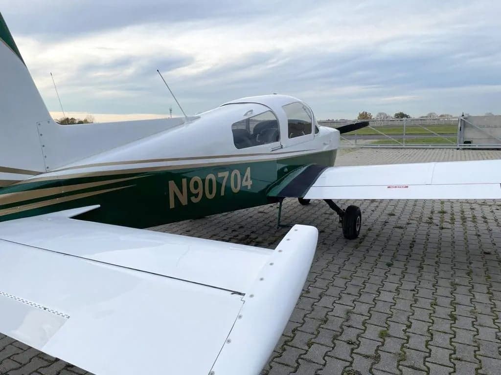Rear side view of N90704 aircraft with registration number visible.