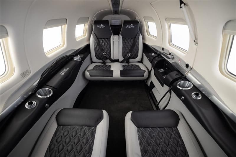 Interior view of a Piper M600 SLS aircraft showing the seats and cabin.