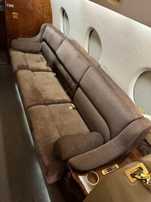 A view of the aircraft cabin seating with brown upholstery.