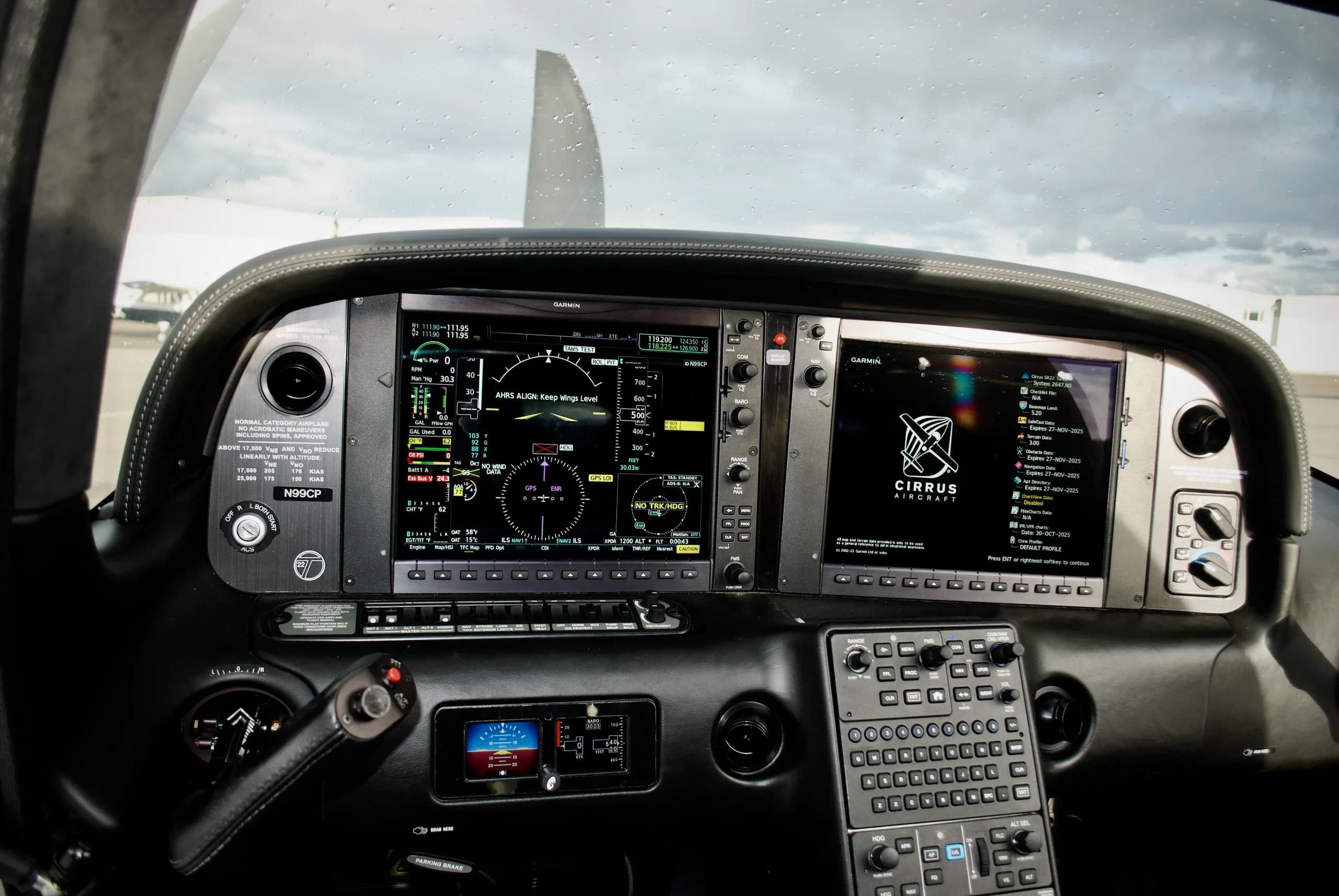 The detailed instrument panel of the Cirrus SR22T cockpit, featuring dual Garmin glass displays and controls.