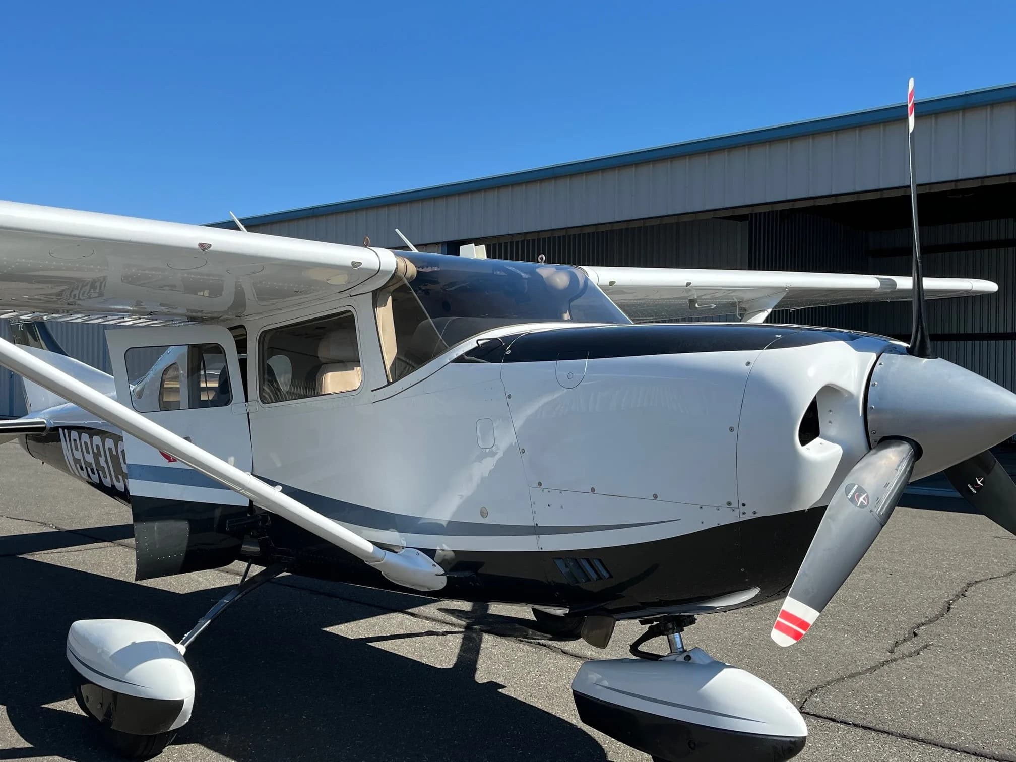 Close up of the Cessna Stationair N993CS showing the nose and wing.