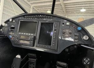 Close-up of the aircraft's instrument panel with multiple displays and controls.